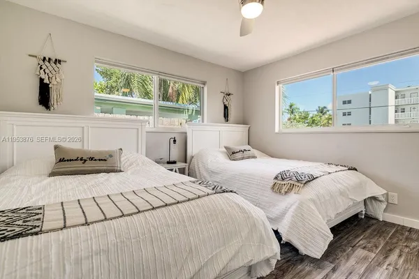 a bedroom with two beds and a window