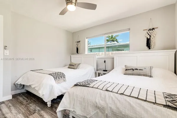 a bedroom with two beds and a chandelier