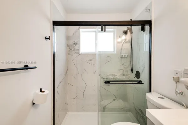 a bathroom with a shower and a sink