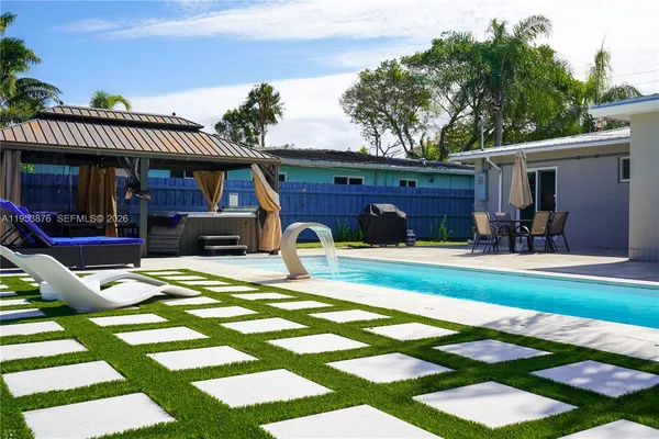 a view of a house with a yard patio and swimming pool