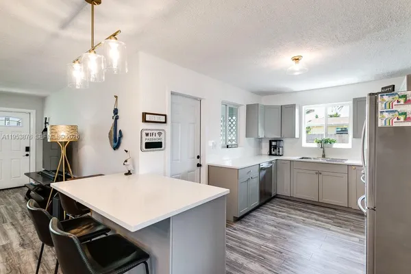 a kitchen with sink cabinets and wooden floor