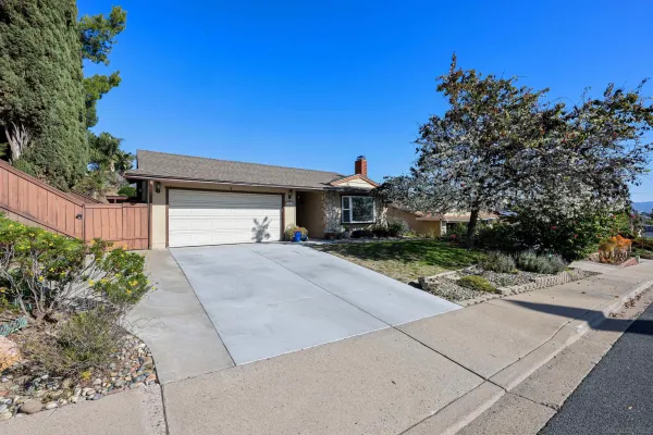 a front view of a house with a yard and a garage