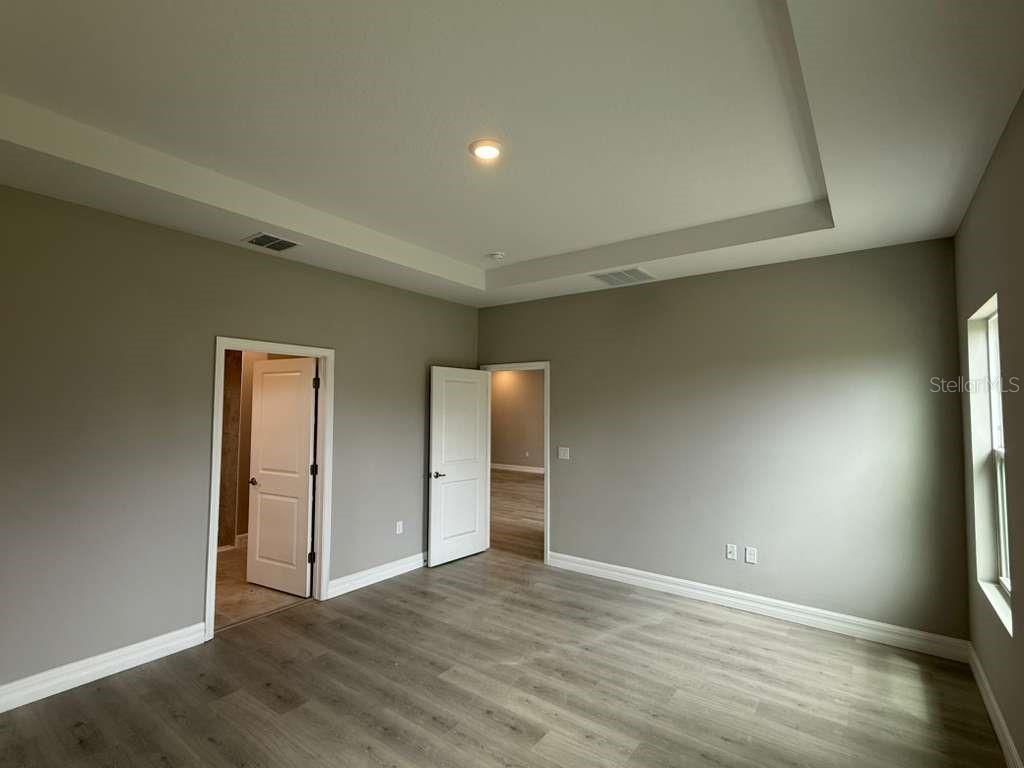 438 Awin Circle Southeast Palm Bay, FL 32909 - Photo 14 of 26 a view of an empty room with wooden floor and closet