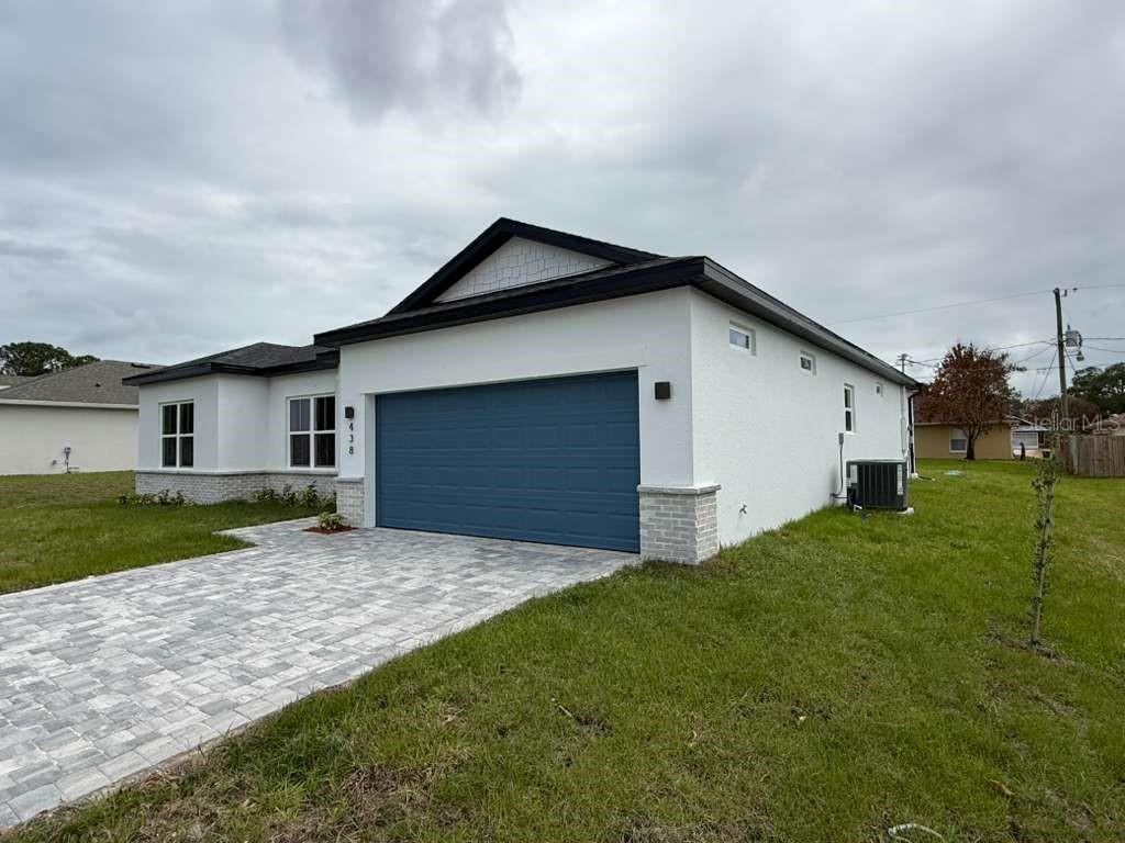 438 Awin Circle Southeast Palm Bay, FL 32909 - Photo 2 of 26 a front view of house with yard and green space