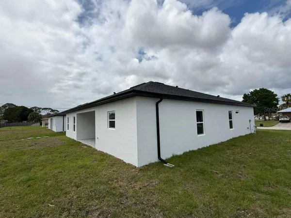 a view of a house with yard and a garden
