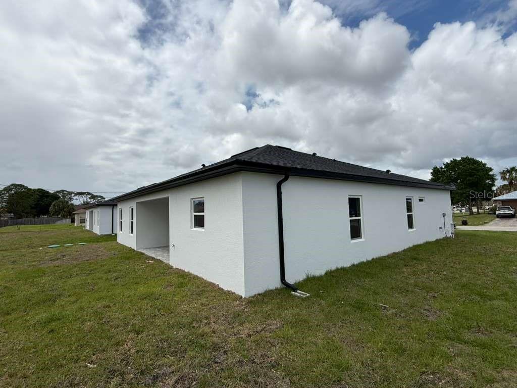 438 Awin Circle Southeast Palm Bay, FL 32909 - Photo 25 of 26 a backyard of a house with lots of green space