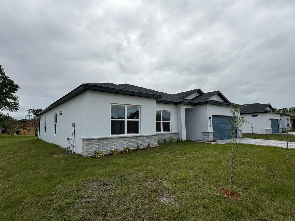 438 Awin Circle Southeast Palm Bay, FL 32909 - Photo 26 of 26 a view of a house with yard and a garden