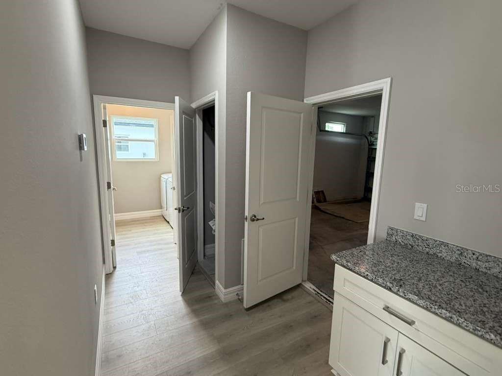 438 Awin Circle Southeast Palm Bay, FL 32909 - Photo 5 of 26 a view of a hallway with wooden floor and closet