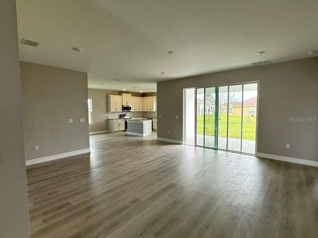 438 Awin Circle Southeast Palm Bay, FL 32909 - Photo 8 of 26 a view of empty room with wooden floor and fan