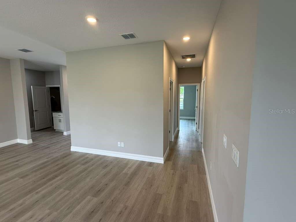 438 Awin Circle Southeast Palm Bay, FL 32909 - Photo 9 of 26 wooden floor in an empty room with a window
