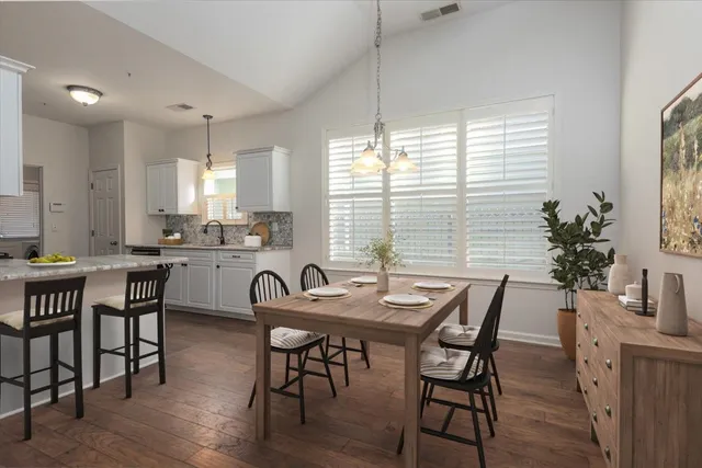 a view of a dining room with furniture and window