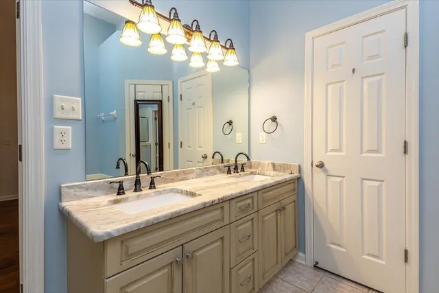 a bathroom with a sink double vanity and a mirror
