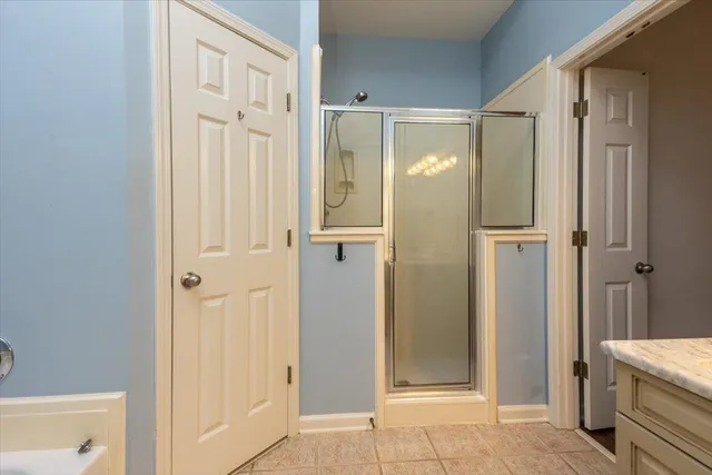 a bathroom with a shower and a glass door