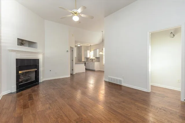 a view of an empty room with a fireplace and a window