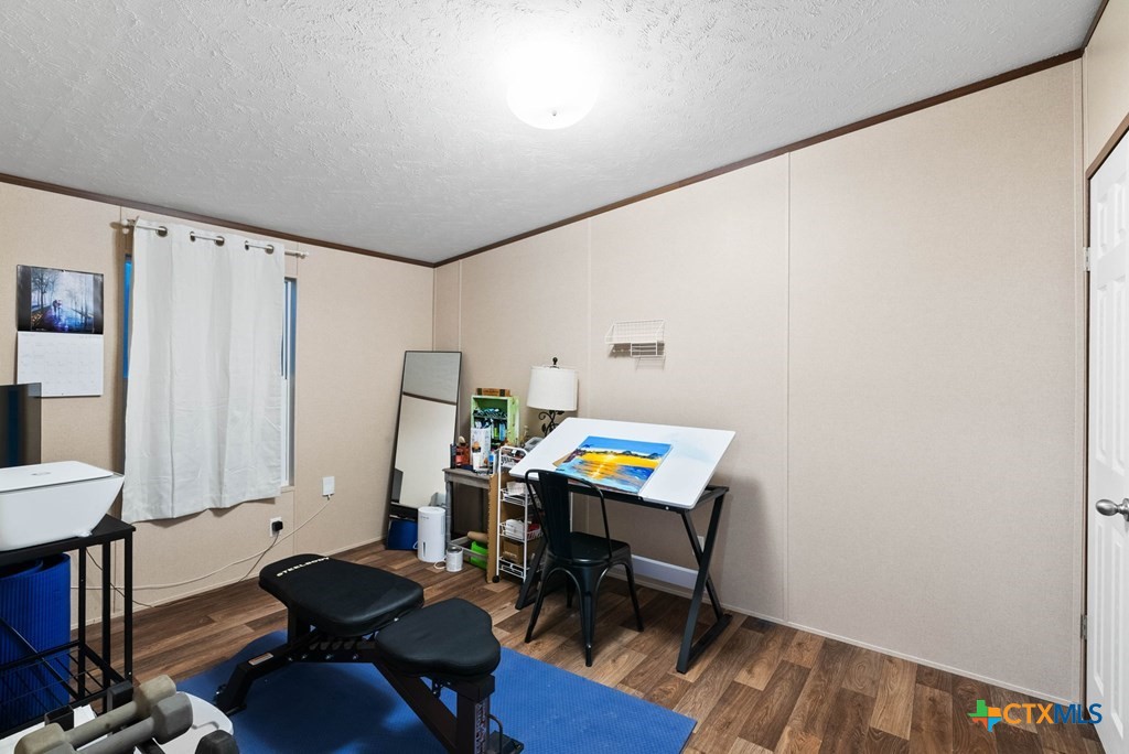 239 Allen M Parks Drive Rockport, TX 78382 - Photo 10 of 29 a workspace with furniture and wooden floor