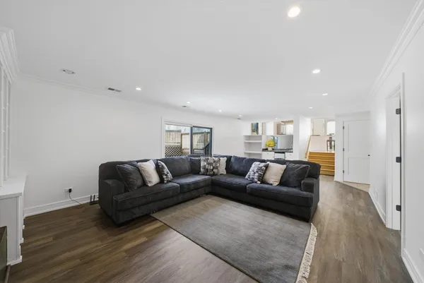 a living room with a couch and a wooden floor