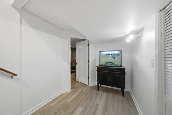 a view of a hallway with wooden floor