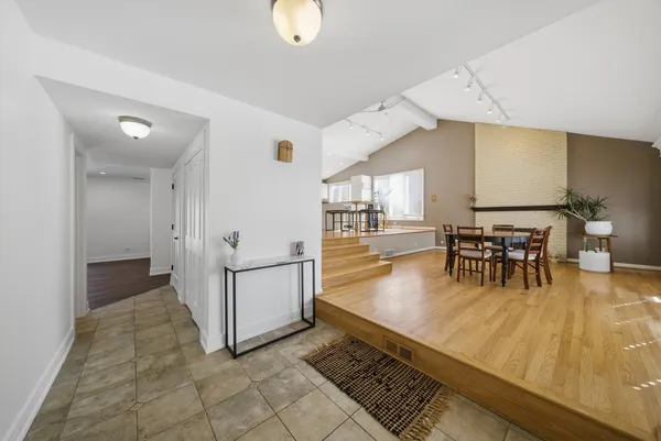 a view of a room with dining room and wooden floor