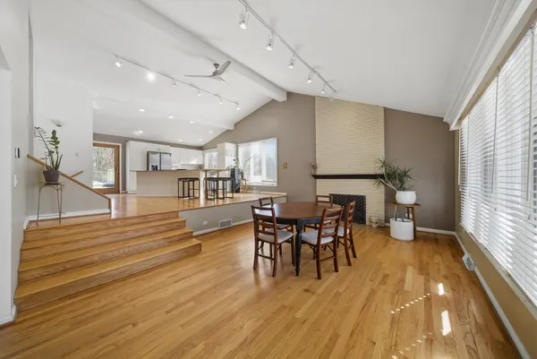 a dining room with furniture and wooden floor