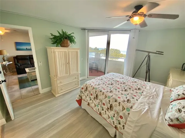 a bedroom with a bed and a mirror on dresser