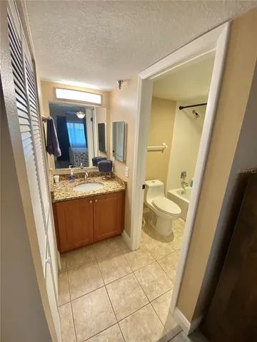 a white toilet sitting next to a shower curtain