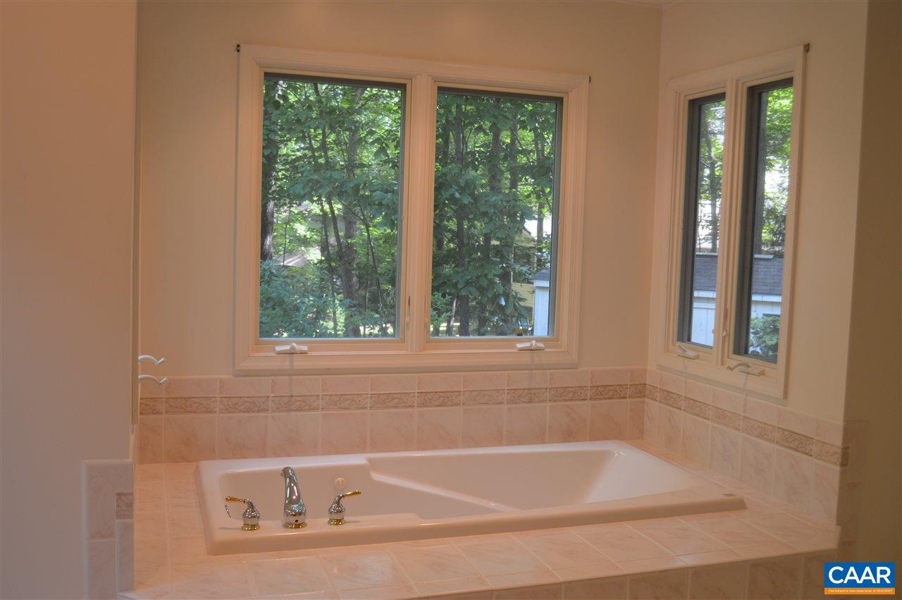 17 Oak Grove Road Palmyra, VA 22963 - Photo 12 of 24 a white bath tub sitting next to a window