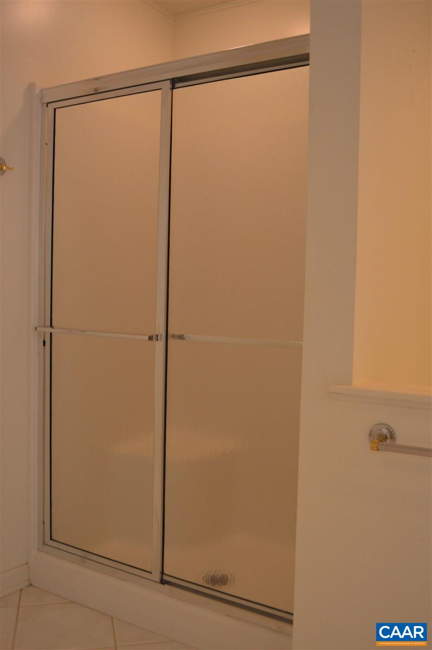 17 Oak Grove Road Palmyra, VA 22963 - Photo 13 of 24 a bathroom with a glass shower door