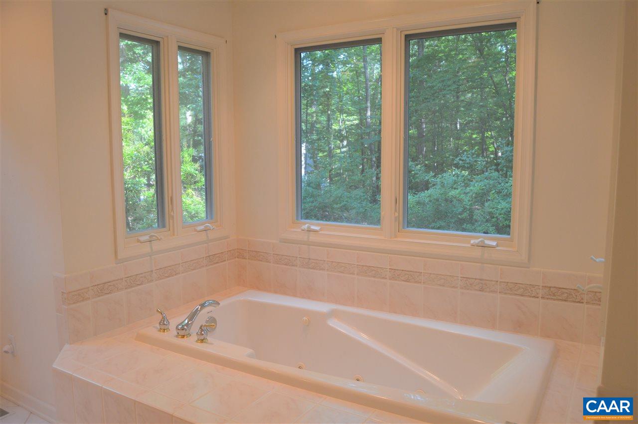 17 Oak Grove Road Palmyra, VA 22963 - Photo 15 of 24 a white bath tub sitting next to a window