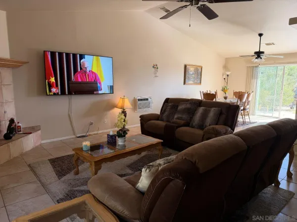 a bedroom with a bed and a fan