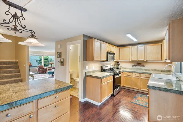 a kitchen with a sink stove and cabinets