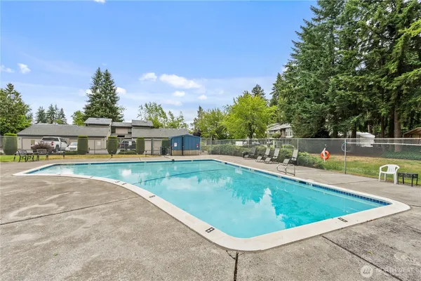 a view of a swimming pool with a yard