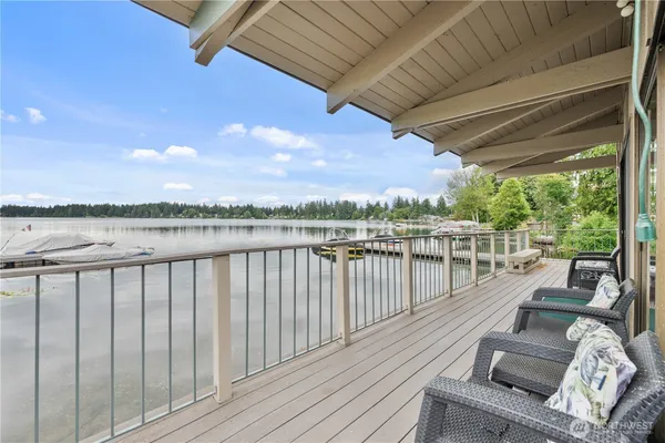 a view of balcony with wooden floor and outdoor seating