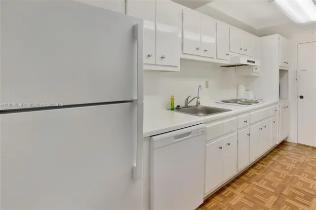 a view of a park with a apartment building in the background