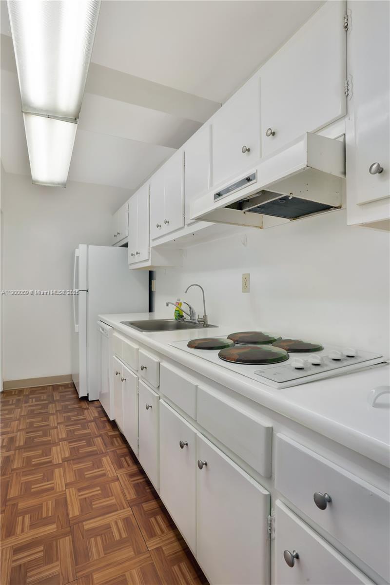 100 Lincoln Road, Unit 607 Miami Beach, FL 33139 - Photo 18 of 30 a kitchen with stainless steel appliances white cabinets and a sink