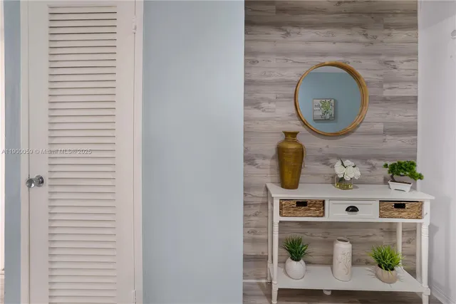 a bedroom with a bed a couch and dresser next to a window