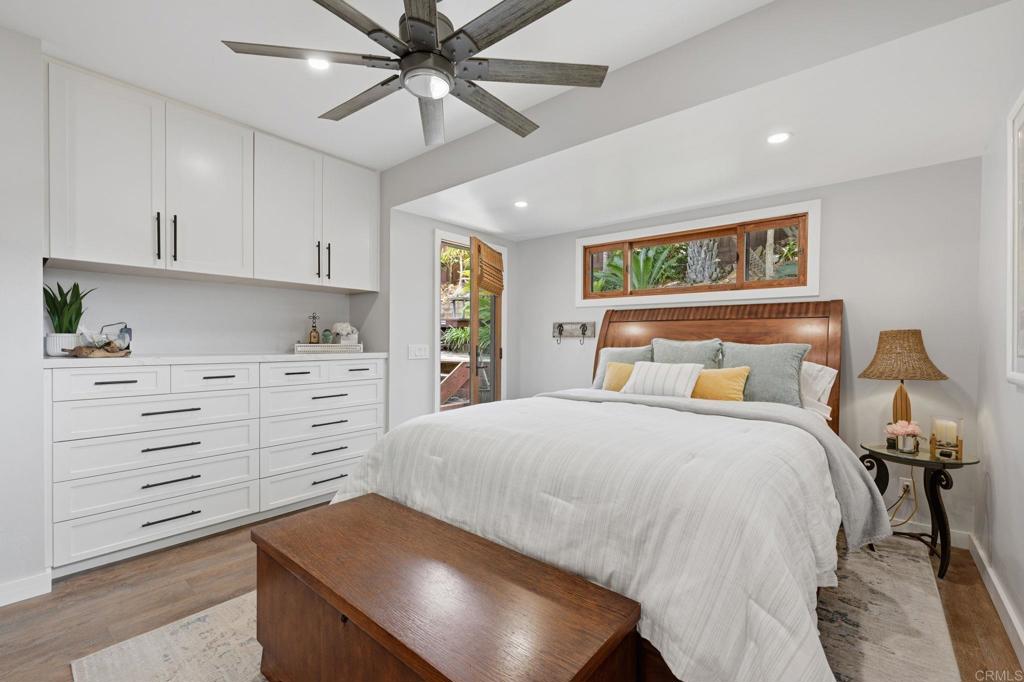 637 Sparta Drive, Unit A & B Encinitas, CA 92024 - Photo 15 of 58 a bedroom with a bed and a chandelier