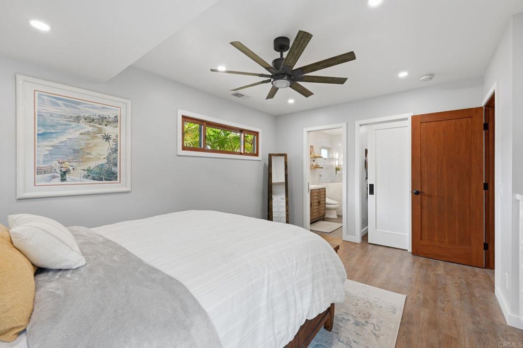 637 Sparta Drive, Unit A & B Encinitas, CA 92024 - Photo 16 of 58 a bedroom with a large bed a painting on the wall and a window