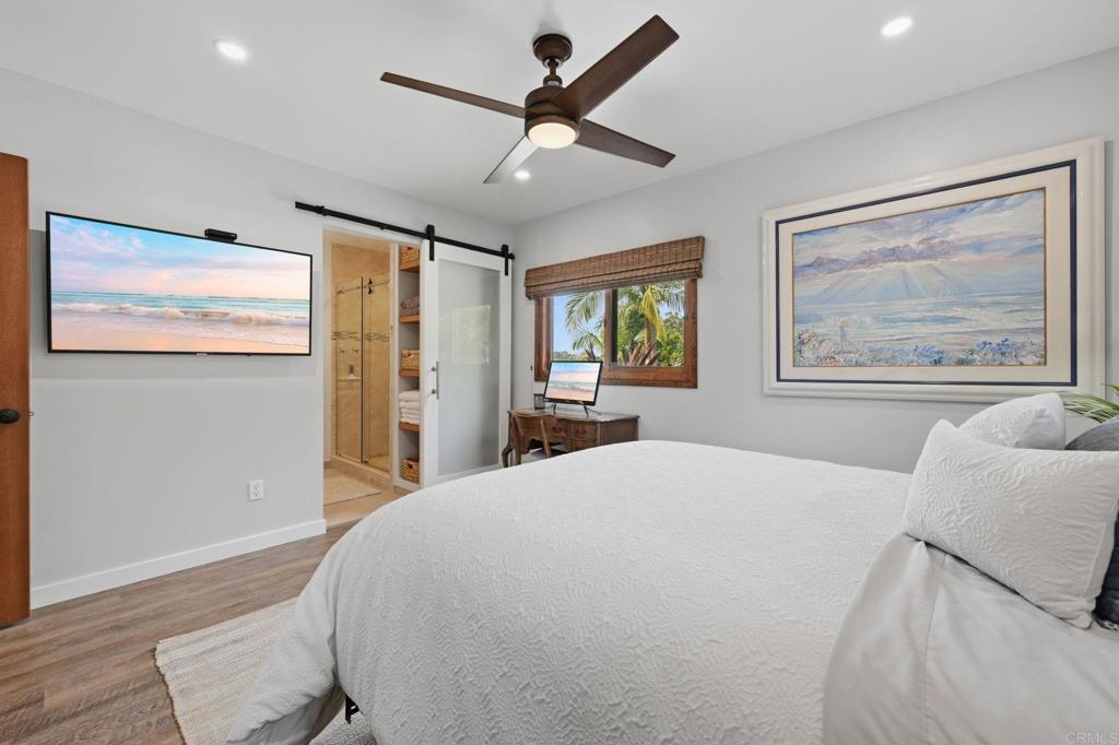 637 Sparta Drive, Unit A & B Encinitas, CA 92024 - Photo 24 of 58 a bedroom with a large bed and a chandelier