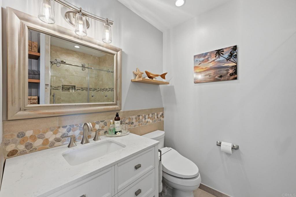 637 Sparta Drive, Unit A & B Encinitas, CA 92024 - Photo 25 of 58 a bathroom with a sink a toilet and a mirror