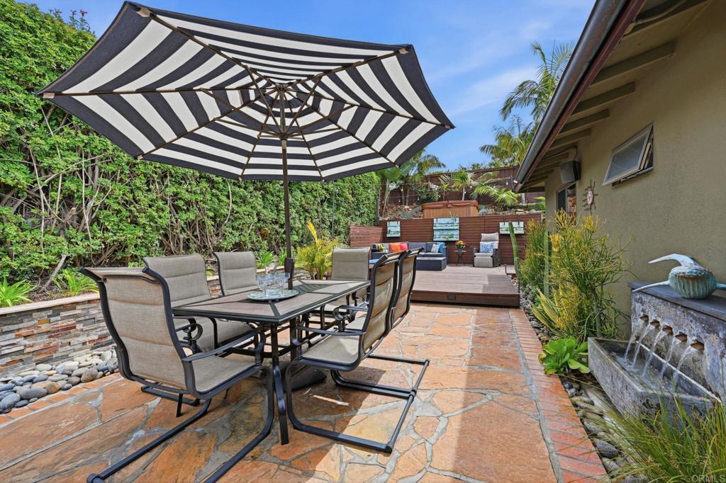 637 Sparta Drive, Unit A & B Encinitas, CA 92024 - Photo 30 of 58 a view of a patio with table and chairs with wooden floor and fence