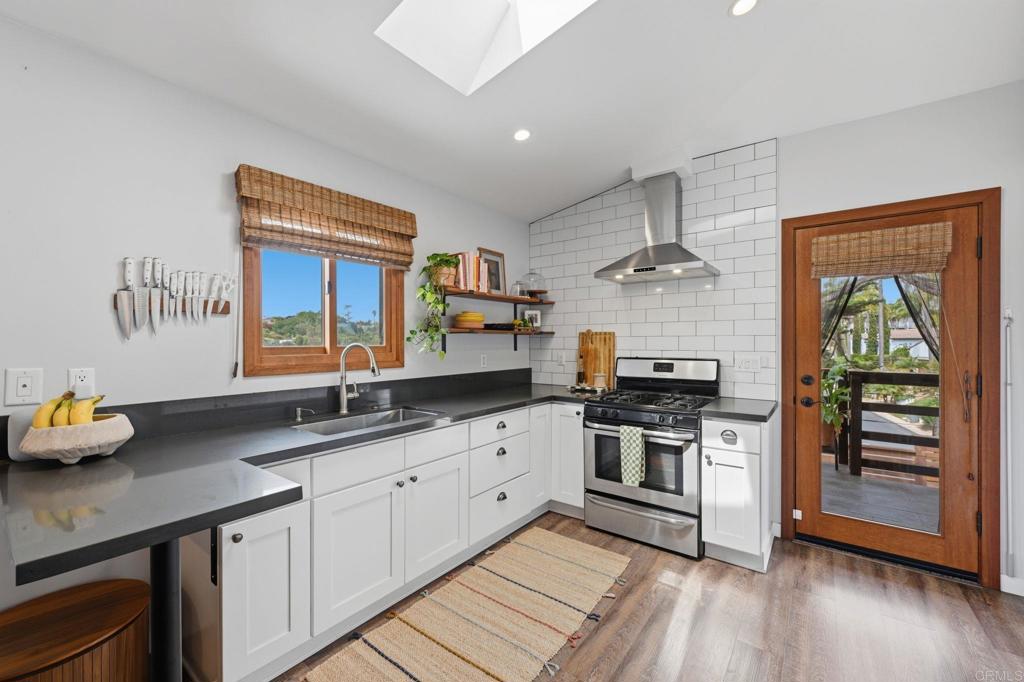 637 Sparta Drive, Unit A & B Encinitas, CA 92024 - Photo 43 of 58 a kitchen with stainless steel appliances granite countertop a sink stove and wooden floor