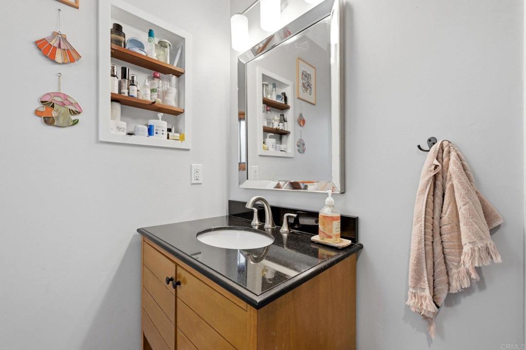 637 Sparta Drive, Unit A & B Encinitas, CA 92024 - Photo 48 of 58 a bathroom with a sink and a mirror