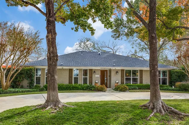 a house that has a tree in front of it