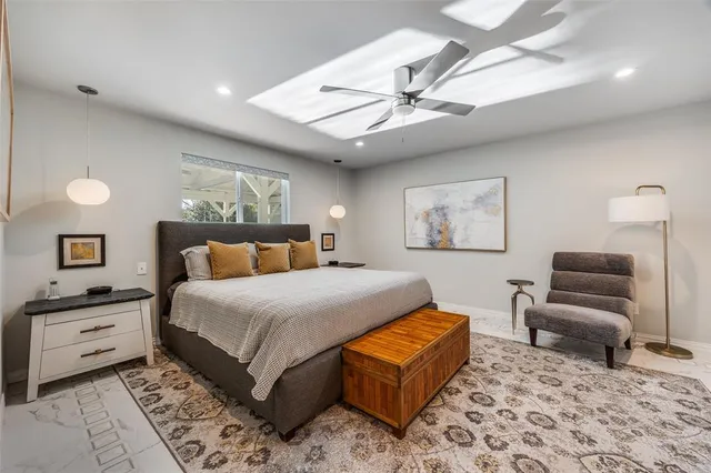 a bedroom with a bed and a chandelier