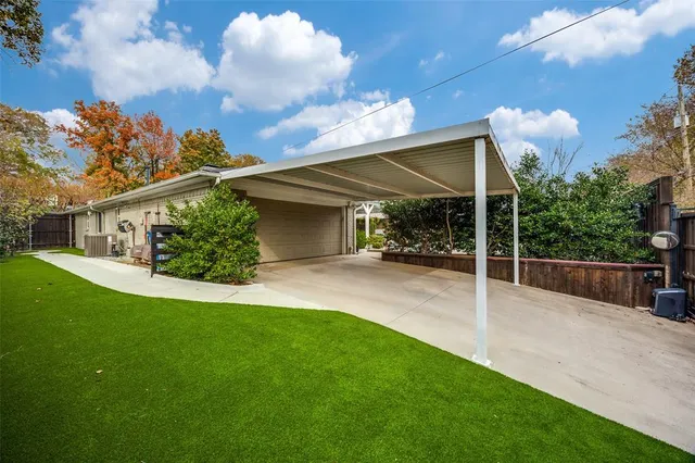 a view of a house with backyard and sitting area