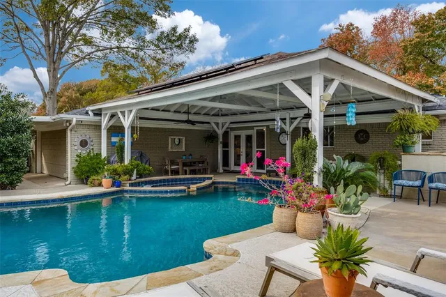 a front view of a house with swimming pool garden and patio