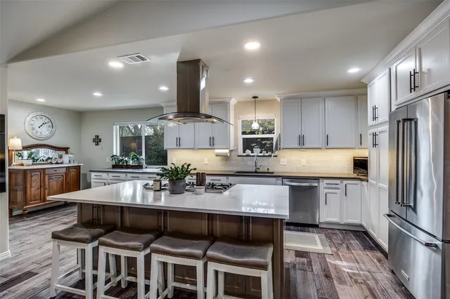 a large kitchen with a table and chairs