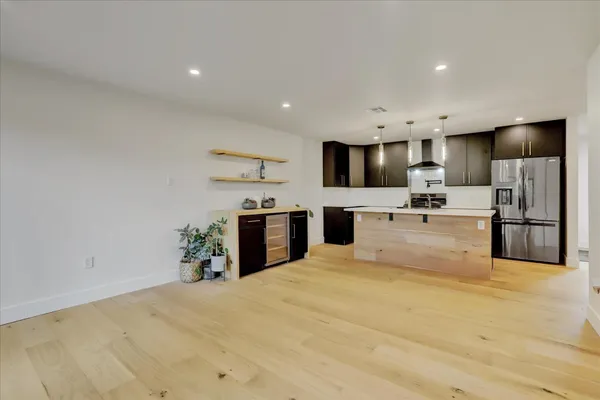 a view of kitchen with microwave oven stove and cabinets