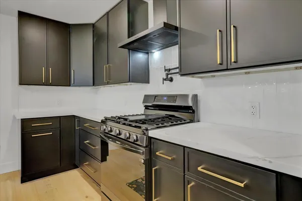 a large kitchen with kitchen island a counter top space a sink and a refrigerator