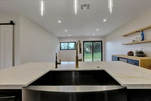 a kitchen with a sink appliances and cabinets